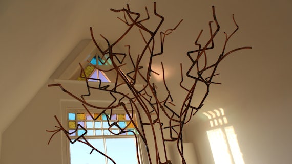Growth by Susan Adams, a tree-like structure made from copper pipes