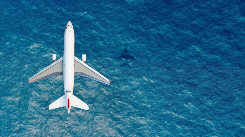 An airplane above a blue sky