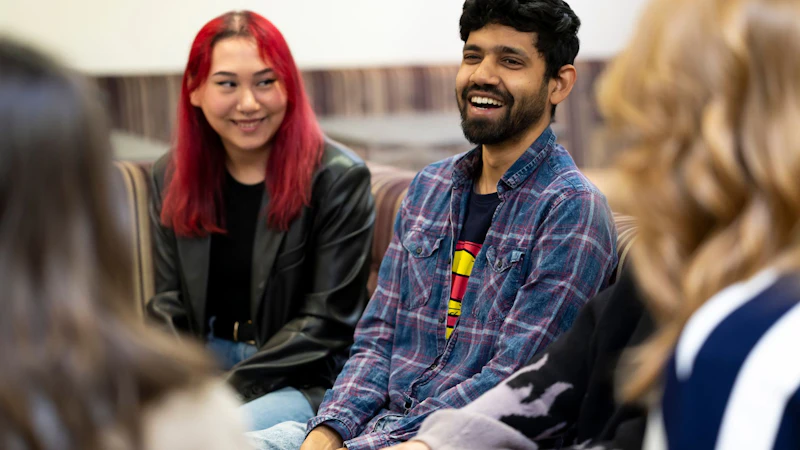 Image of students laughing and chatting in a canteen