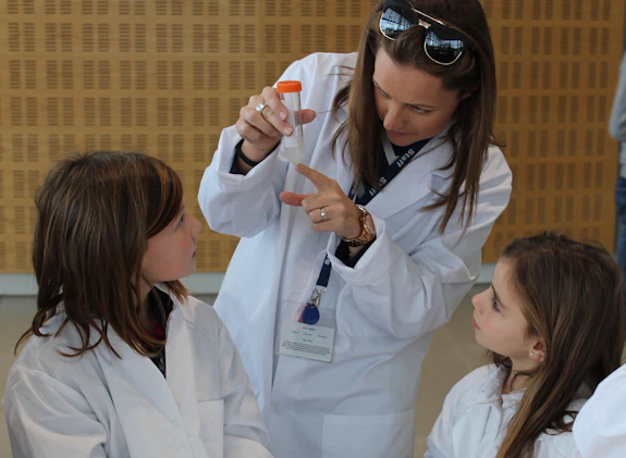 Two children and teacher examining DNA