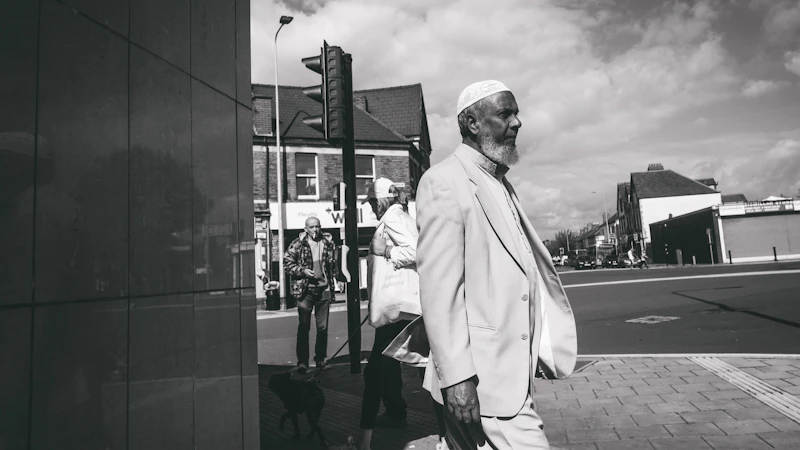 People walking in the sunshine at a road junction