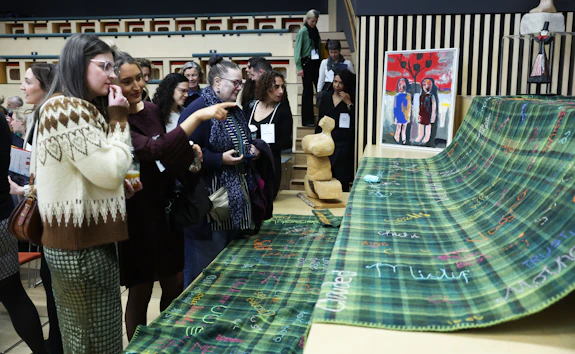 Women looking at a blanket at the Women’s Health Research Wales launch