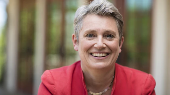 A portrait of a woman wearing a suit.
