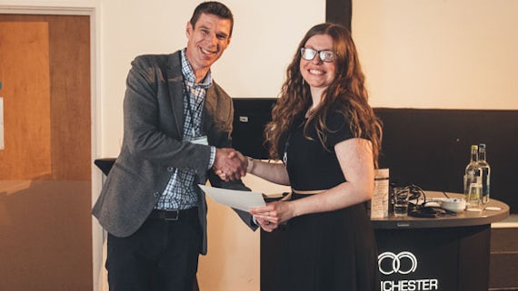 Dr Rick Short, NDA Research Manager, presenting Danielle with the best oral presentation award.
