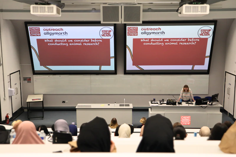 Students in a large lecture theatre taking part in a Step Up masterclass on ethical considerations in animal research.