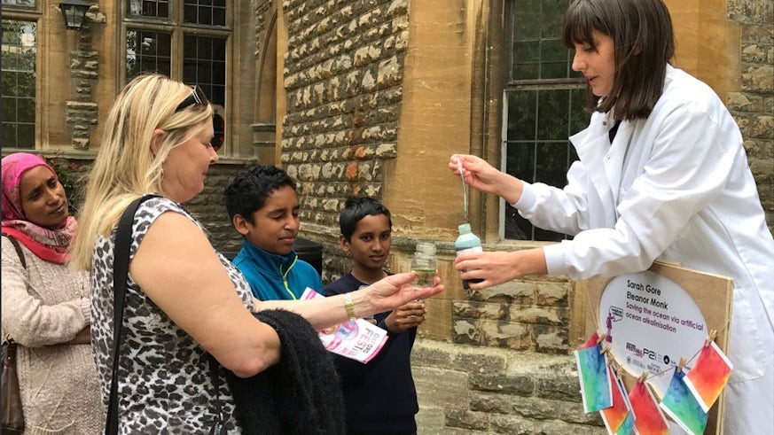 PhD student Sarah Gore demonstrating the use of indicator fluid at Soapbox Science Oxford