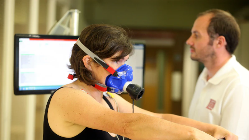 Physiotherapist works with patient on cardiorespiratory equipment