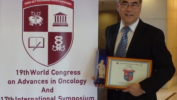 Professor Wen Jiang accepting award in Athens
