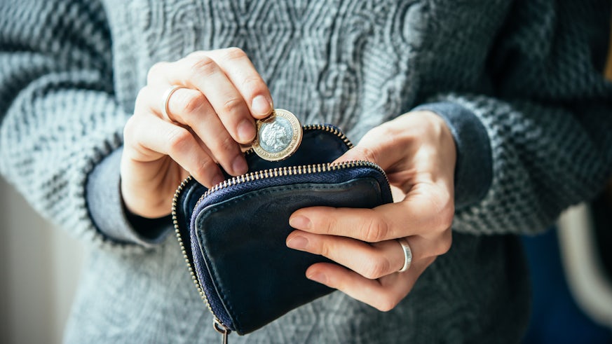 Woman sorting coins in her purse stock image