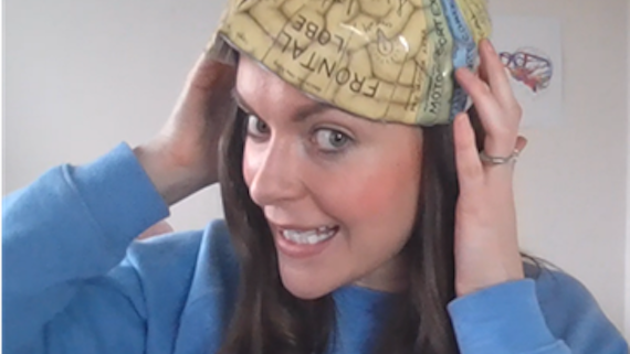 Dr Emma Yhnell fitting a brain overlay on to her head