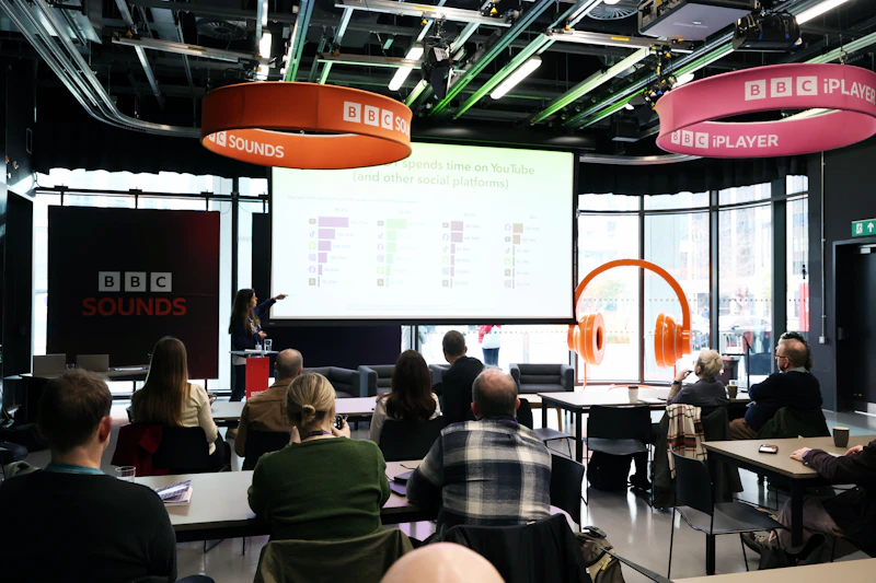 People sitting in a room and watch a presentation