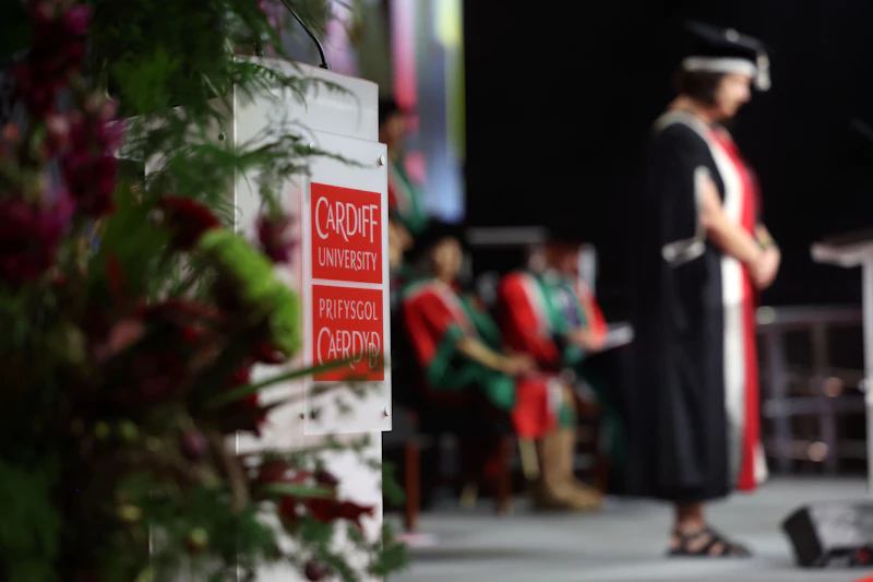A Cardiff University lectern is photographed at a graduation ceremony.