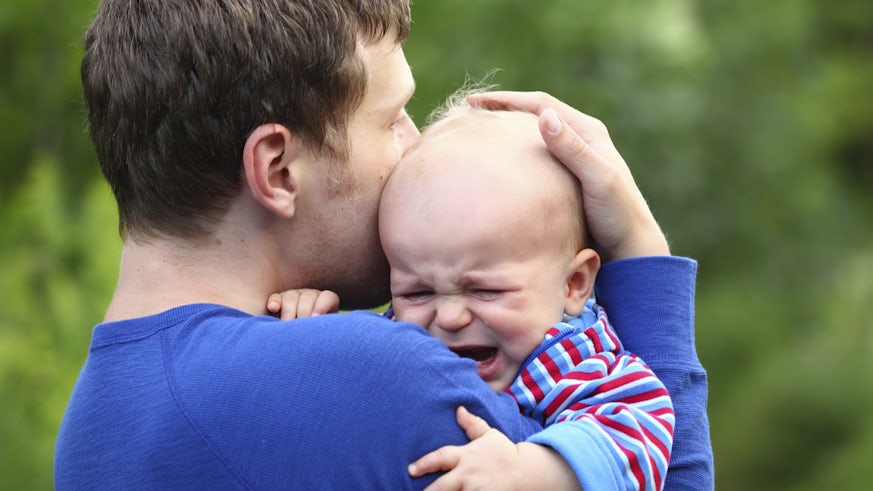 Father consoling crying child