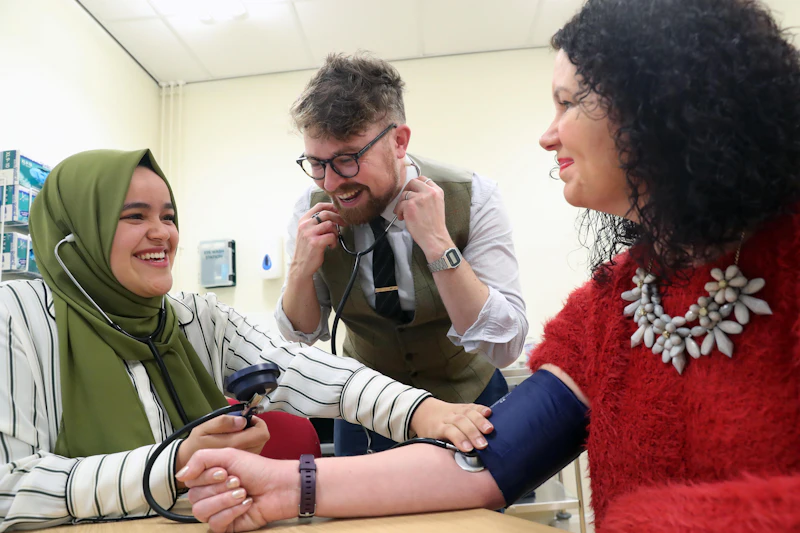 student taking blood pressure with Martyn and Lisa