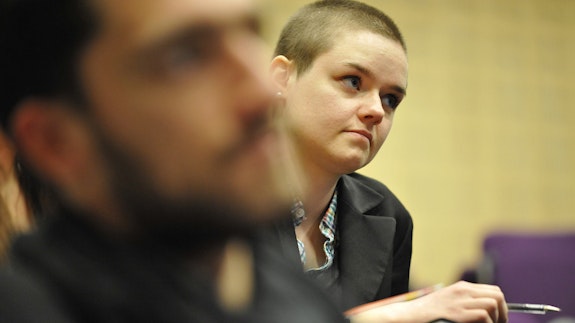 Close up of a student sitting in a lecture hall