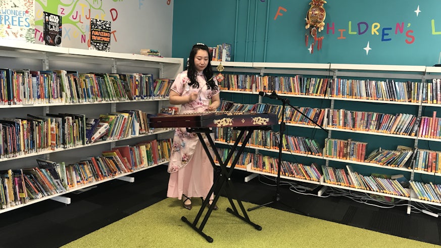 Girl playing Chinese instrument