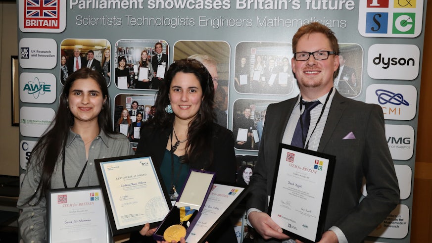 Two young women and one young man pose for a photograph with their awards at STEM for BRITAIN 2024 in Westminster.