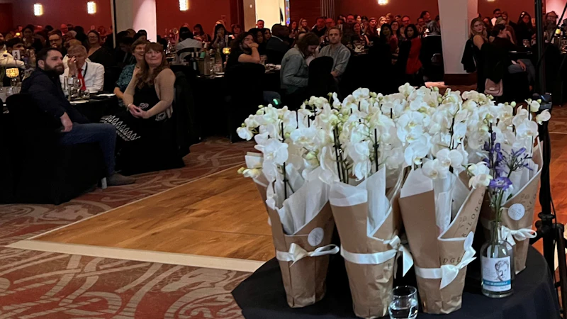 Flowers with the conference dinner attendees in background