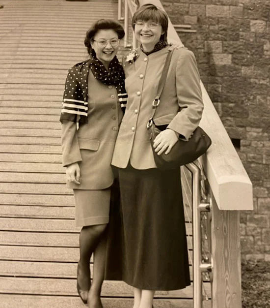 A black and white photo of two ladies in front of Castell Coch steps