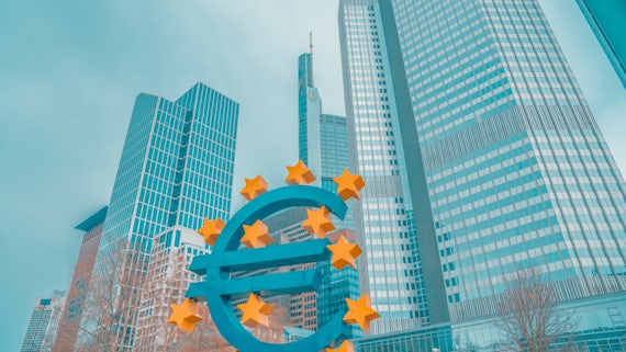 Euro sign in front of skyscrapers