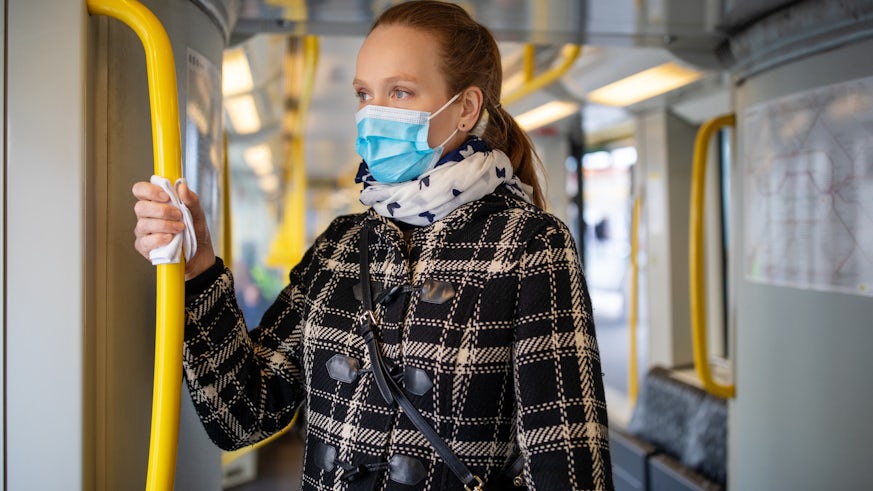 Stock image of woman in a mask on public transport
