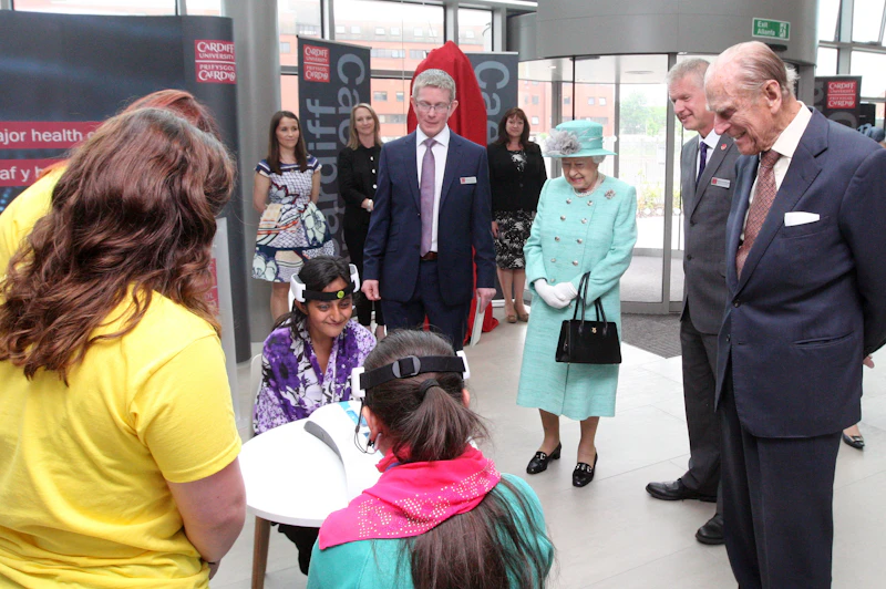 The Queen and Prince Philip watch children taking part in a science experiment