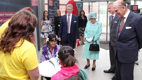 The Queen and Prince Philip watch children taking part in a science experiment
