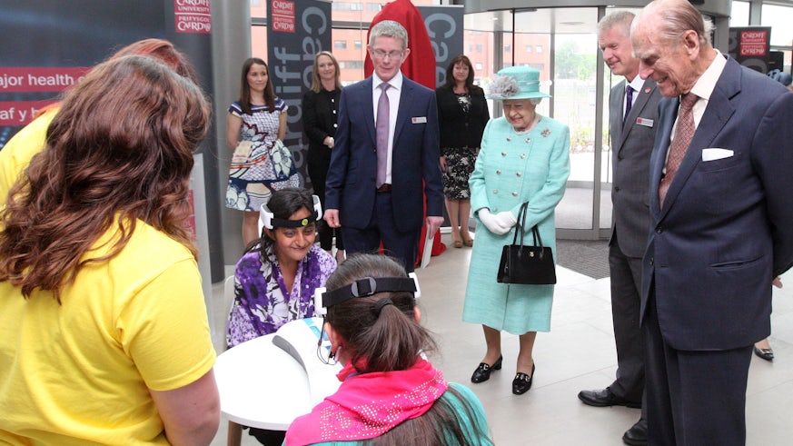 The Queen and Prince Philip watch children taking part in a science experiment