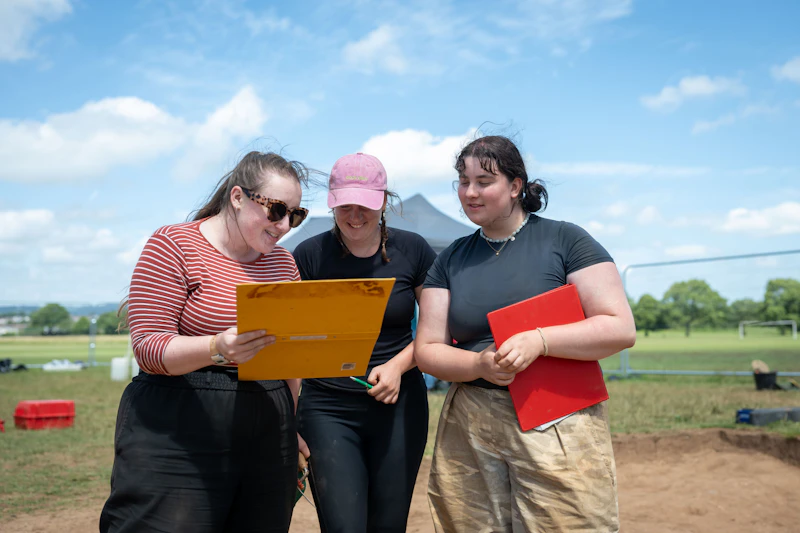 Three archaeologists analysing work