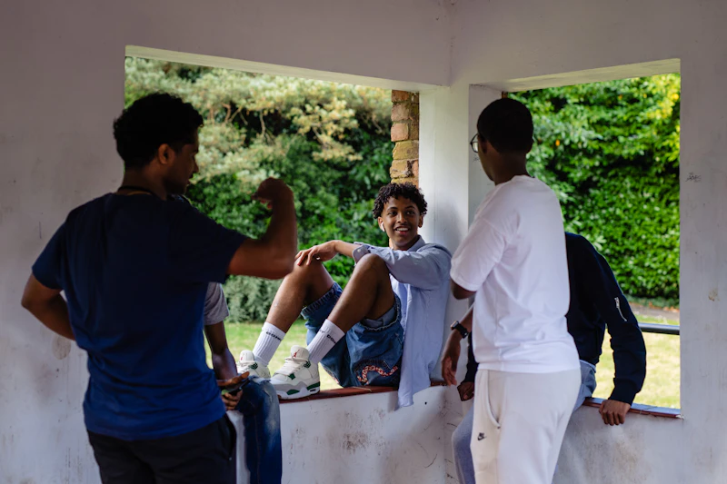 A group of participants talking and spending time together in an outdoor shelter at the Step Up summer school.